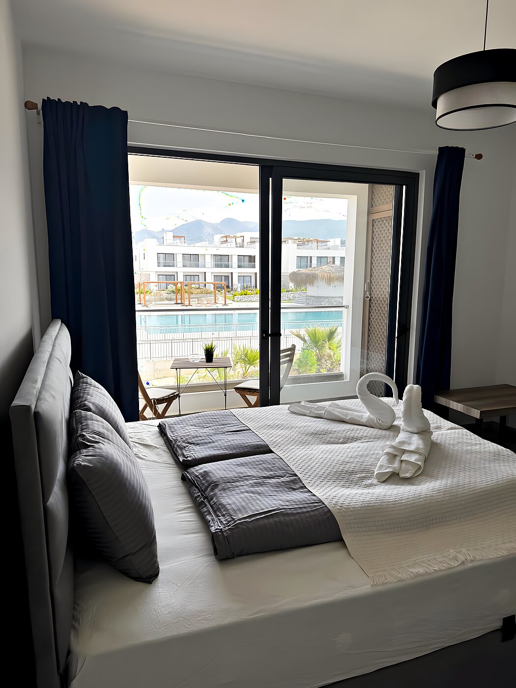 Bedroom with a double bed and a view of the pool