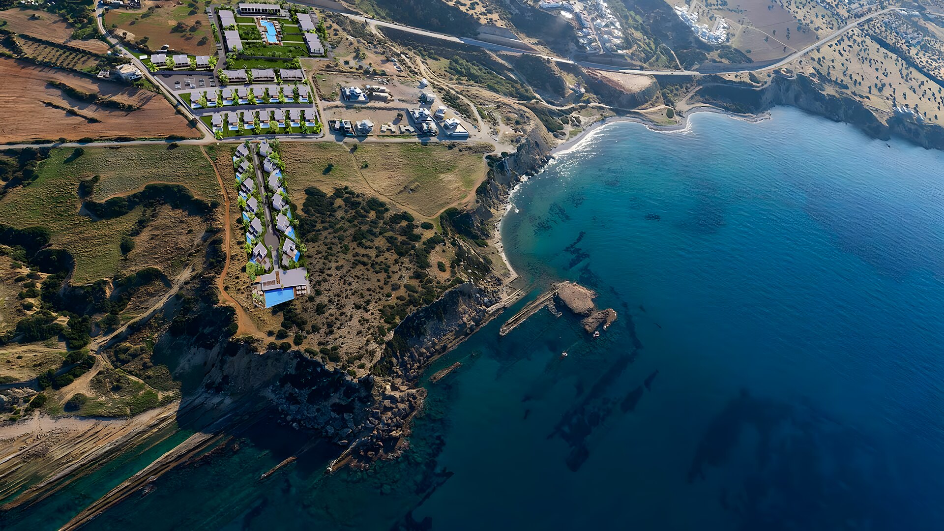 Aerial view of the Bahçeli coastline with turquoise coves and the resort